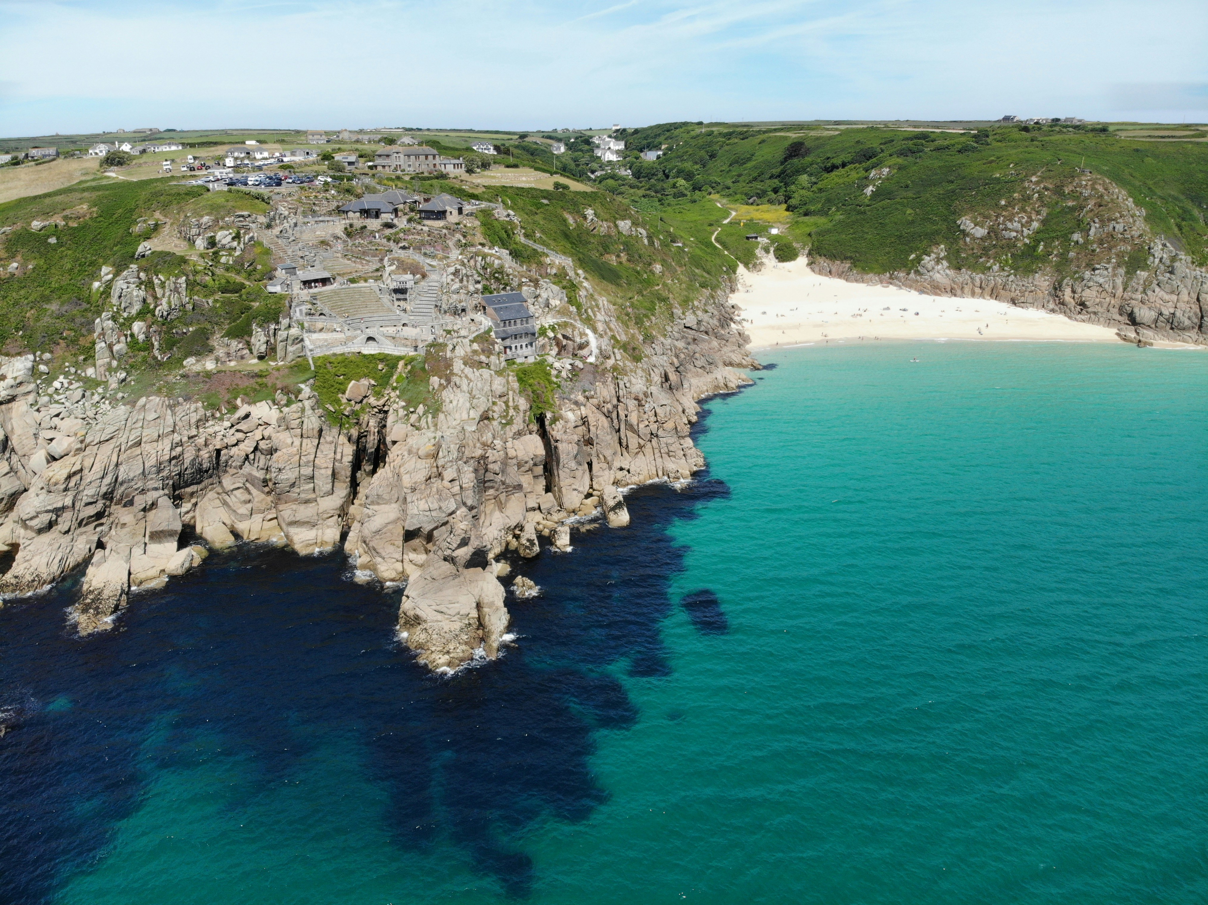 Cliffs and a fishing village along the Cornwall coast path in England