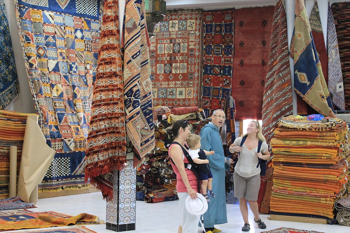 Jen and our oldest, with a friend of ours, talking with a local rug merchant in a shop hung with dozens of handwoven Moroccan rugs