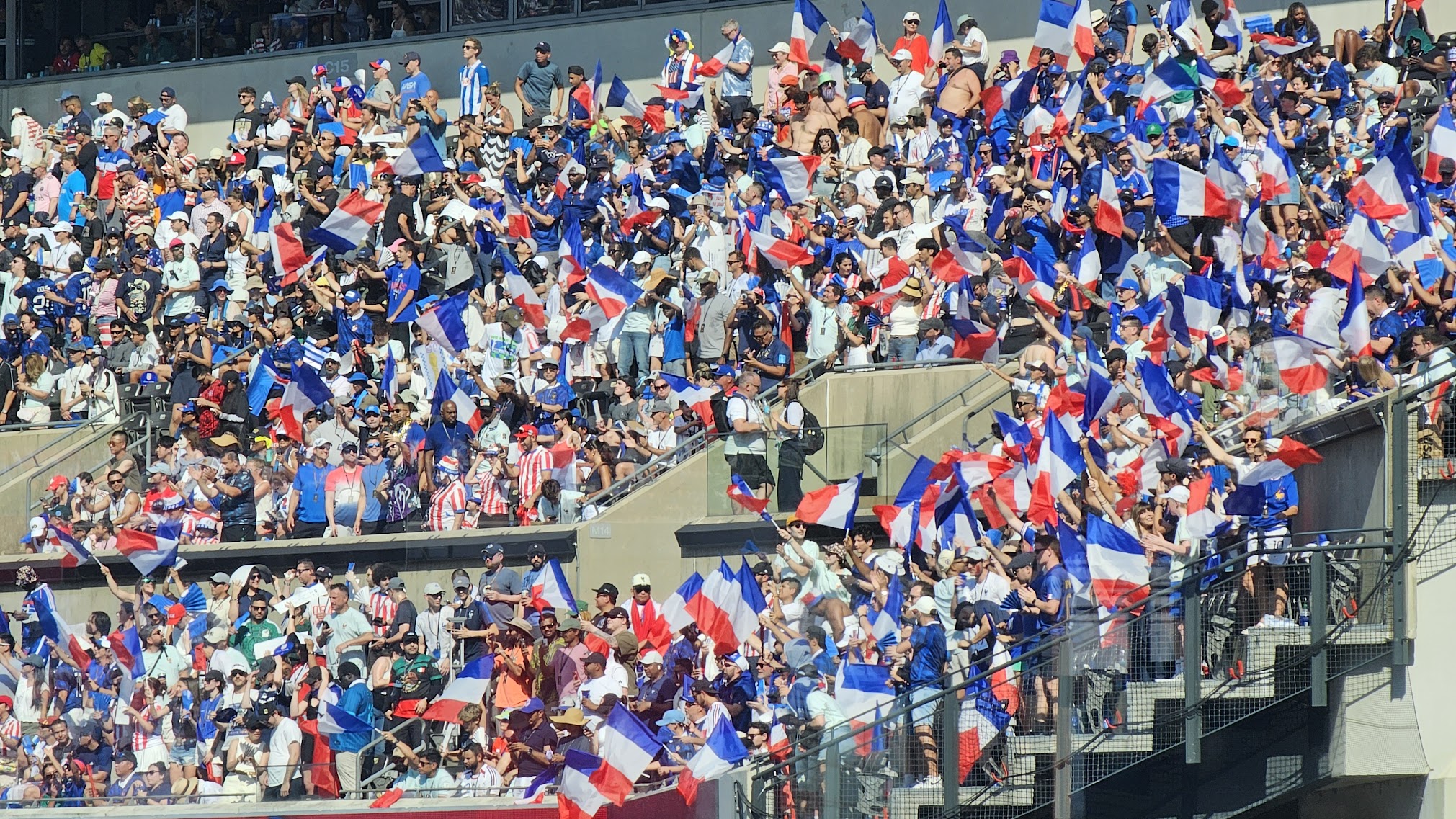 Rows of French fans waving French flags in the stands at Lincoln Financial Field
