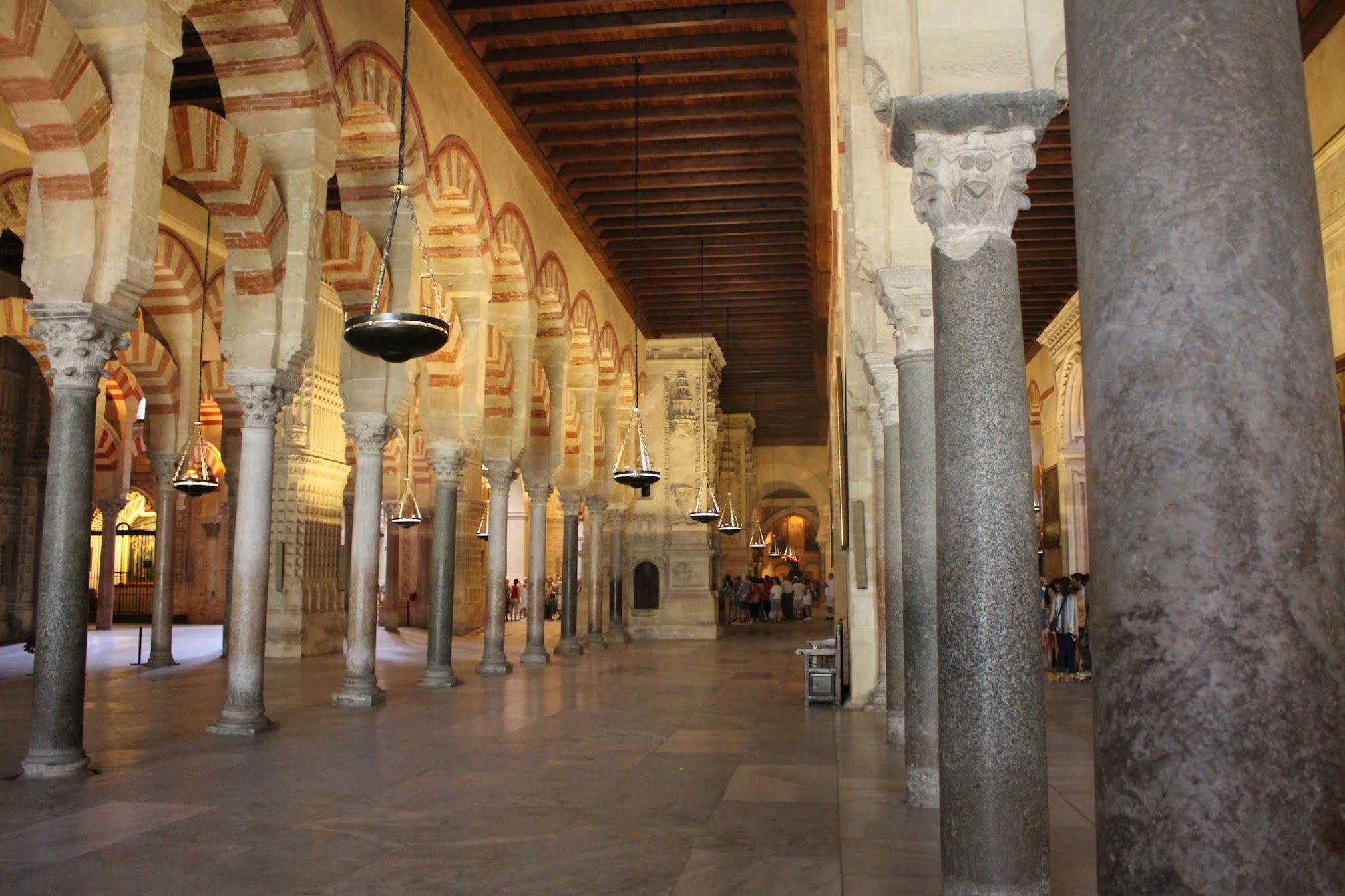 The famous forest of columns inside the Mezquita in C&oacute;rdoba, Spain, with distinctive red-and-white striped horseshoe arches receding into the distance
