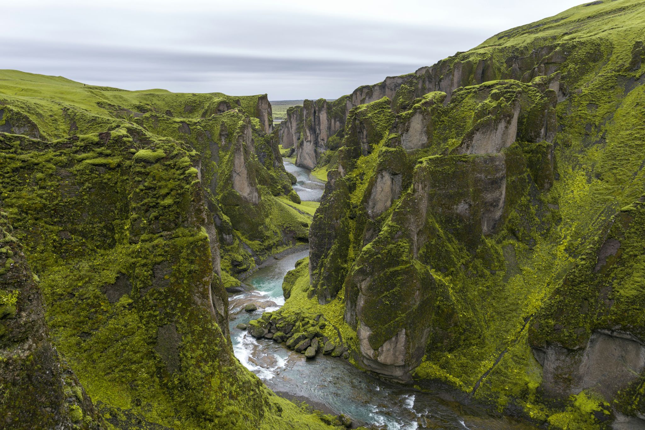 An open road cutting through a dramatic volcanic landscape in Iceland